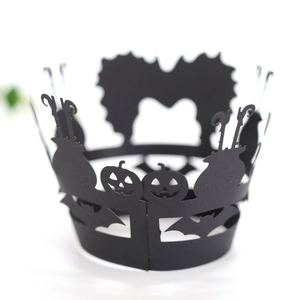 Detail of laser-cut black Halloween cupcake wrappers with pumpkin and bat patterns