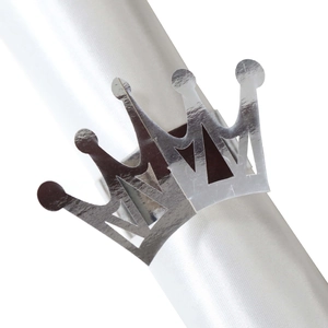 Macro detail of silver crown napkin ring with mirror polished finish on white silk
