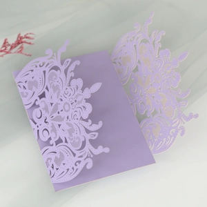 Detail of laser-cut floral pattern on light purple pearlescent paper wedding invitation