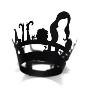 Detail of black Halloween cupcake wrapper featuring witch and cauldron silhouettes