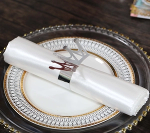Close-up of a silver crown napkin ring with high-gloss mirror finish for banquet decor