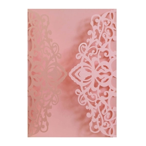 Detail of pink laser-cut wedding invitation showing intricate mandala floral pattern