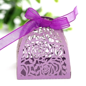 Close-up of laser-cut rose patterns on purple gift box with silk ribbon bow