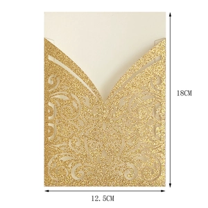 Detailed view of laser-cut gold glitter wedding invitation with floral scroll patterns