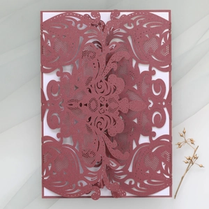 Detail of laser-cut floral pattern on pearlescent cardstock for wedding invitations