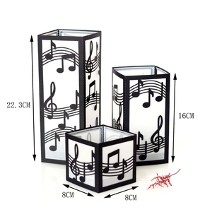 Three sizes of black laser-cut musical note candle shades with 22.3cm height detail