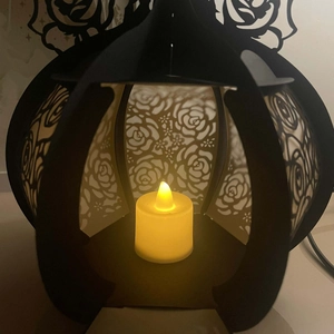 Detailed view of镂空 hollow rose lantern with warm yellow LED candle light for home decor