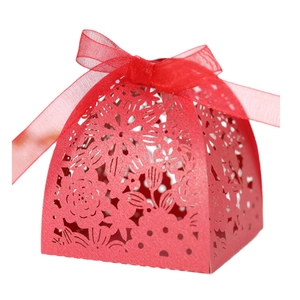 Laser-cut red wedding favor box with floral patterns and a matching red chiffon ribbon bow