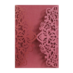Detailed laser-cut mandala pattern on burgundy wedding invitation cover with shimmer finish