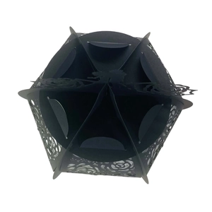 Macro view of black hexagonal paper lantern featuring laser-cut rose hollow patterns