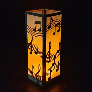 Vertical music note paper lantern with warm LED light and hollow staff patterns