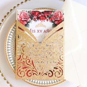 Detail of laser-cut glitter gold Quinceañera invitation with red rose floral design