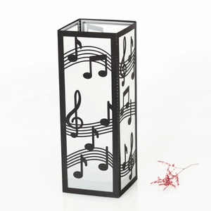 Detailed view of black laser-cut musical note paper lantern shade with sheet music motifs