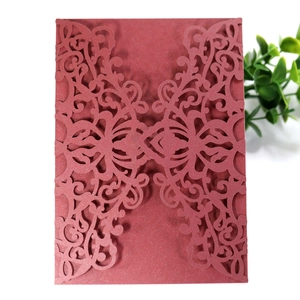 Detailed laser cut floral vine pattern on burgundy pearlescent paper invitation cover
