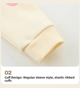 Detail of light beige girl's hoodie showing elastic ribbed cuffs and knit cotton texture