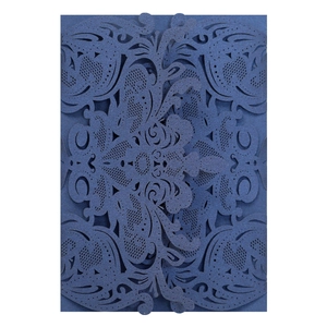 Detail of laser-cut navy blue floral lace wedding invitation with pearlescent finish