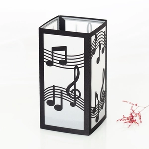 Detailed view of hollowed-out musical note paper lampshade with staff and clef pattern
