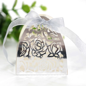 Detailed laser-cut silver candy box with rose pattern and matching satin ribbon bow