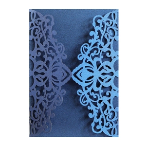 Intricate laser-cut navy blue lace mandala patterns on shimmering pearlescent cardstock