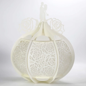 Detail of laser-cut hollow rose patterns on a cream white paper carriage decoration