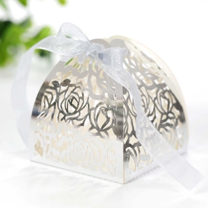 Detail of silver laser-cut rose hollow candy box with metallic finish and silk ribbon