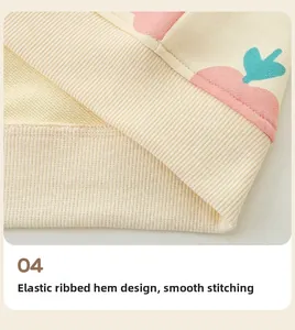 Detail showing elastic ribbed hem of beige kids hoodie with pink abstract pattern