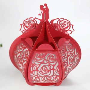 Detail of red 3D hollow paper lantern with rose pattern and bride and groom silhouette
