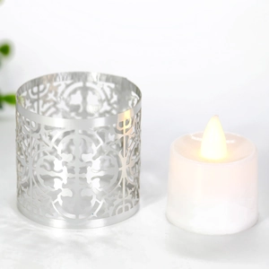 Detailed view of silver hollowed-out metal candle holder with elegant laser-cut patterns