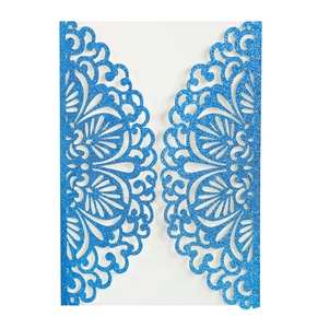 Detail of laser-cut blue glitter wedding invitation with intricate floral lace patterns