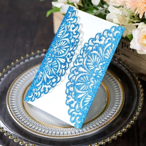 Intricate laser-cut blue glitter wedding invitation card with elegant floral lace patterns