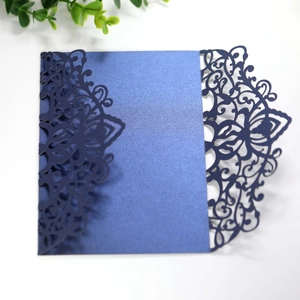 Detailed laser cut dark blue wedding invitation sleeve with intricate floral patterns