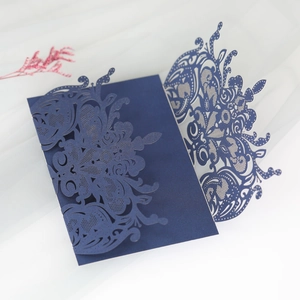 Detail of laser-cut lace pattern on navy blue pearlescent wedding invitation card