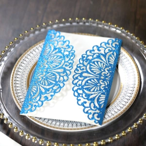 Detail view of blue glitter laser-cut lace wedding invitation with white insert card
