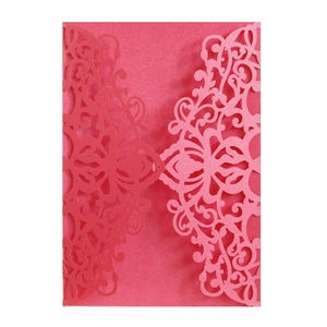 Detailed laser-cut floral pattern on deep pink wedding invitation card sleeve