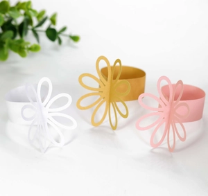 Detail of laser-cut petal napkin rings in reflective gold, white and soft pink paper