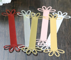 Detail of laser-cut flower petal napkin rings in multiple metallic finishes and colors