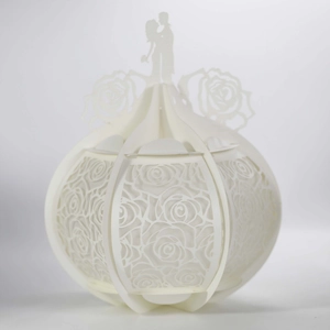 Detailed laser-cut rose patterns and couple silhouette on white paper lantern