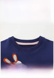 Close-up of ribbed crew neck and cute rabbit embroidery on navy blue girls sweatshirt