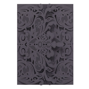 Detail of laser-cut wedding invitation featuring intricate grey floral hollow design