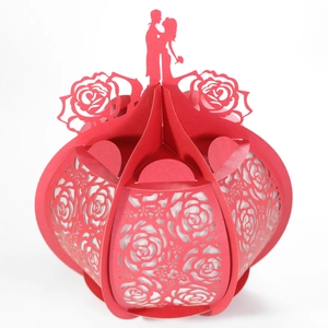 Detailed laser-cut red paper gift box with romantic rose patterns and couple silhouette
