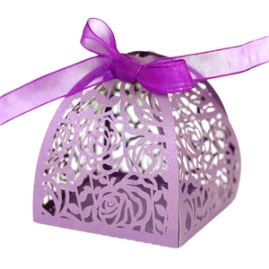 Lilac laser-cut wedding favor box with rose patterns and dark purple organza ribbon bow
