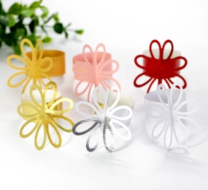 Close-up of 6 colorful floral napkin rings featuring delicate hollow petal designs