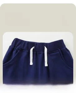 Detail view of boys' navy knit joggers featuring an elastic waistband and white drawstrings