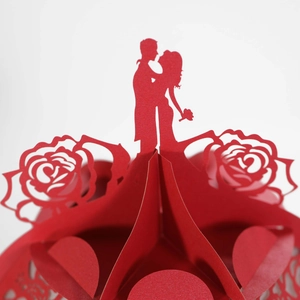 Macro shot of 3D paper cut heart lamp featuring a romantic couple and hollow rose patterns