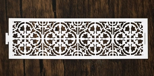 Macro detail of white laser-cut napkin ring with a continuous symmetrical pattern design