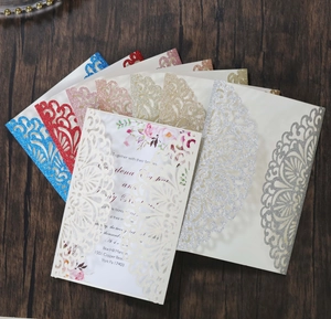 Detail of laser-cut rose gold glitter paper wedding invitations in various elegant colors