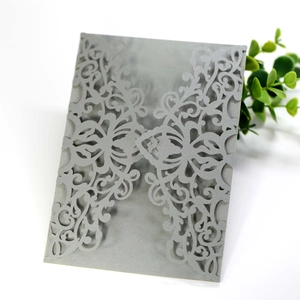 Detailed laser-cut grey invitation sleeve with elegant lace patterns for weddings