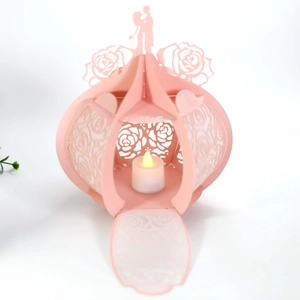 Detailed pink laser-cut rose lantern with warm LED candle for romantic decor