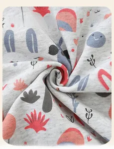 Detailed macro view of soft grey knit fabric with cute cartoon rabbit and rainbow prints