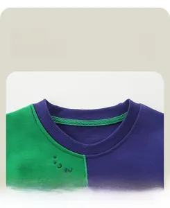 Detail of soft ribbed crewneck on two-tone green and purple kids' sweatshirt